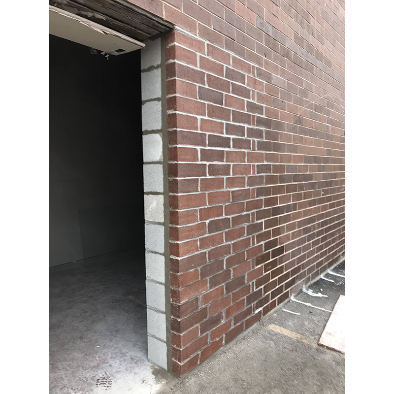 Exterior masonry repair and building. Door and window installation.