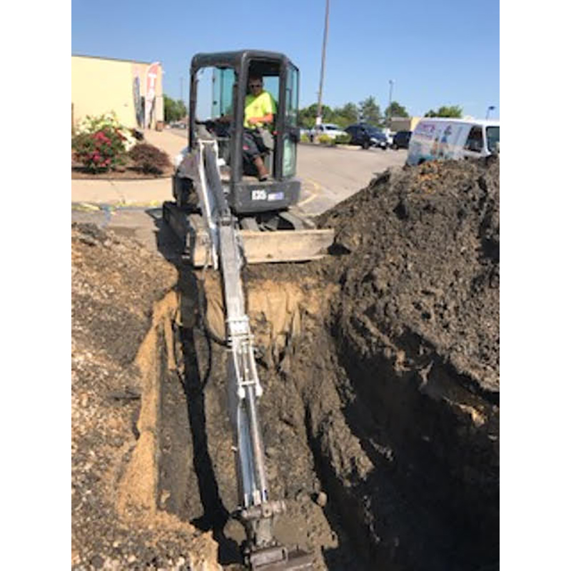 Excavating outside location preparing for sewer line repair.