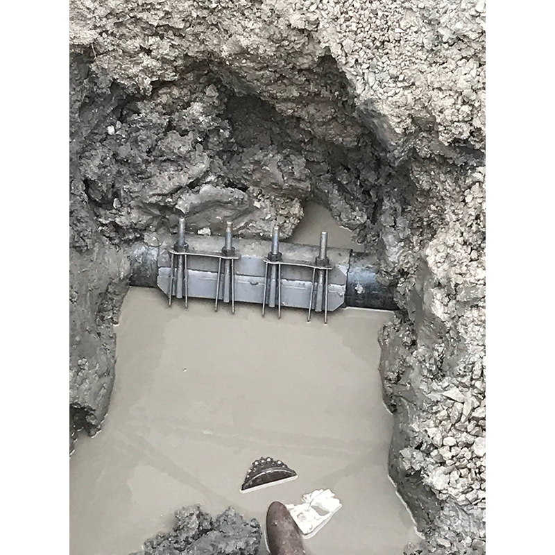 Repaired sewer line with fitting.